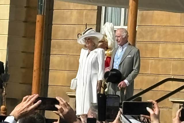 King Charles and Queen Camilla make their entrance on the palace terrace.