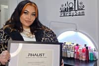 Makeup artist Samantha McBean in her salon with her finalist certificate.