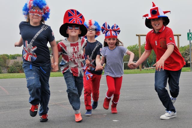 Clavering Primary School pupils run to their Jubilee party in 2012. Pictured are James Hepple, Ben McMorris, Jayden Flush, Libby Cox and Daniel Shaw.