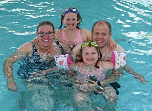 Darren Anderson and Emily Anderson, pictured with daughters Olivia, six and Sophie, nine.