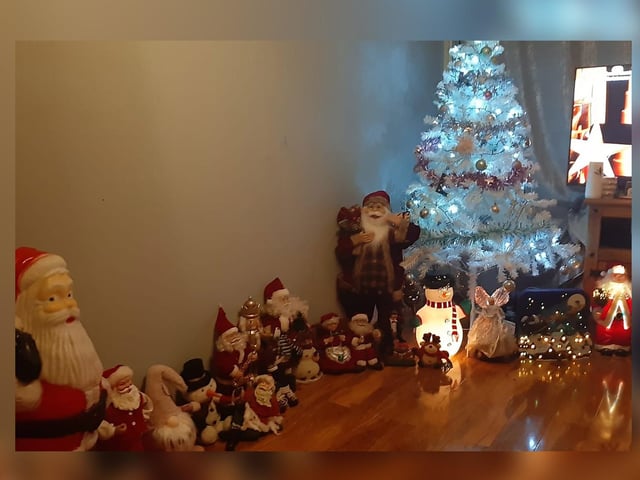 Santa and his helpers unite around the tree.