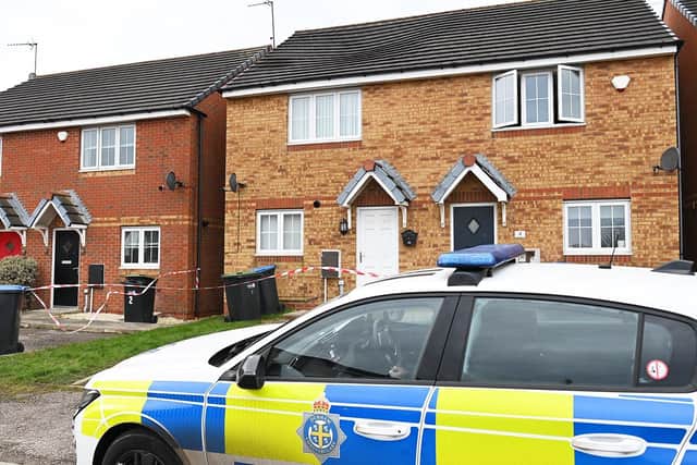 Police in Eden Court, Horden, following a fire at the house with the white door on January 19.