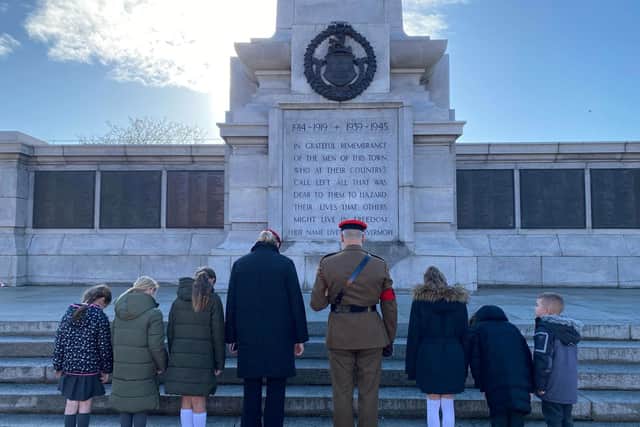 Pupils pay their respects to soldiers past and present at the cenotaph in Victory Square.