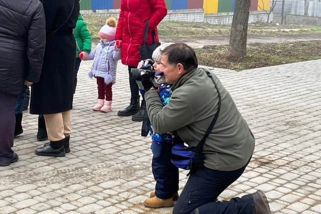 Andy shares some of his photo taking tips with a little girl in Muzykivka.