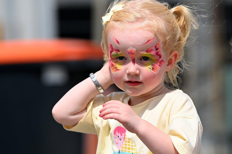 This little one has had her face painted for the occasion.