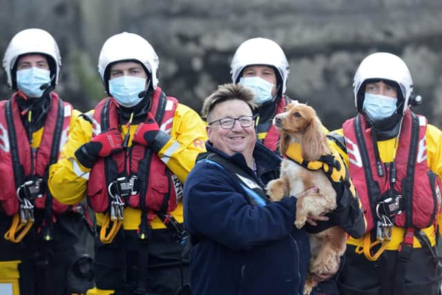 Stuart Lawson with his dog Jinx and Hartlepool RNLI lifeboat crew, from left to right, Colm Simpson, Jordan Craddy, Darren Killick and Tim Boagey. Photo by RNLI/Tom Collins.
