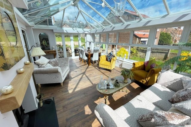 The conservatory features a log burner and French doors to the rear garden.