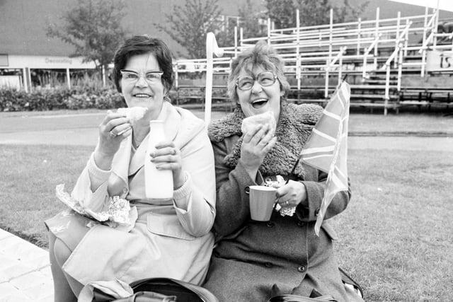 These two ladies pick out the perfect spot to get a glimpse of the Queen during her visit to the town in 1977.