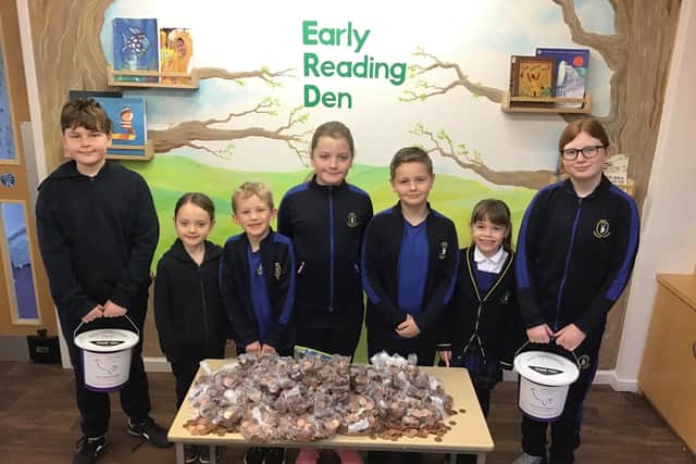 Hart Community Primary School pupils with bags of money they raised.