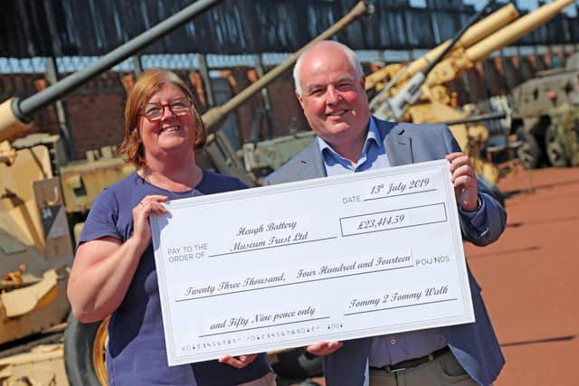 Diane Stephens receives a cheque from 2019's Tommy To Tommy sponsored walk from Councillor Dave Hunter. Picture: Tom Banks