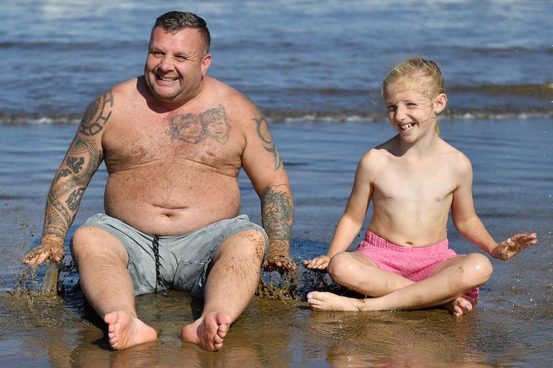 Mark Earl with his daughter, Layla-Marie Earl, cooling down in the sea at Seaton Carew. Picture by FRANK REID