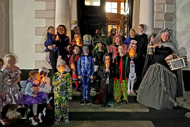 Jo Banks (far right) as The Grey Lady with youngsters and families who joined in the Stranton ghost walk.