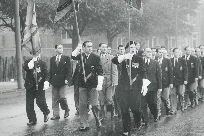 Soldiers parade towards the memorial in the 1950s.