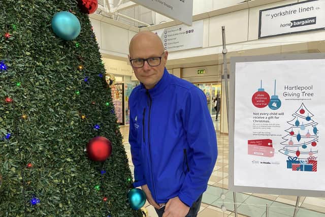 Middleton Grange Shopping Centre manager Mark Rycraft alongside the 2020 Christmas Giving Tree