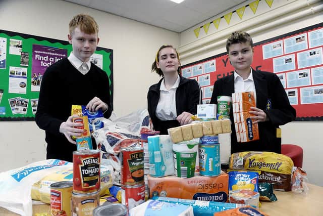 Hartlepool Pupil Referral Unit pupils (left to right) Callum Cockerill, Elinor Dangerfield and Amy Russell with a selection of donated items to the new foodbank. Picture by FRANK REID