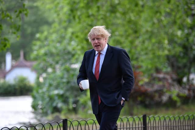 Prime Minister Boris Johnson takes a morning walk in St James's Park in London. Picture: PA.