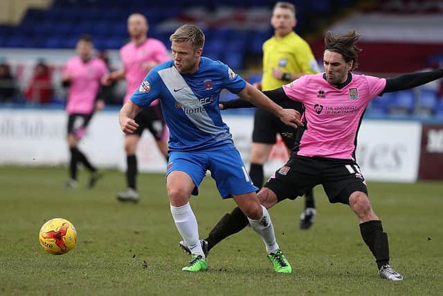 Nicky Featherstone of Hartlepool United looks to move away from the challenge of Ricky Holmes of Northampton Town during the Sky Bet League Two match between Hartlepool United and Northampton Town at Victoria Park on February 27, 2016 in Hartlepool, England.  (Photo by Pete Norton/Getty Images)