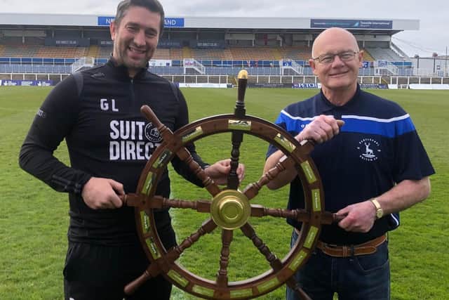 Graeme Lee (left) receives the ship's wheel from engraver Billy Reid of First Class donated by Marine Supplies in Brenda Road, Hartlepool.