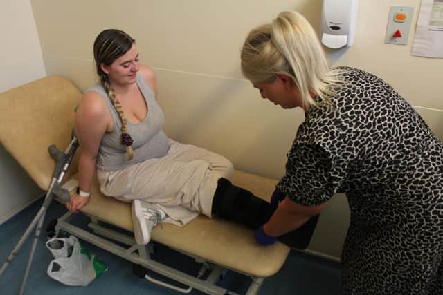 Emily Hanley receives treatment from senior surgical care practitioner Beth Alderton.