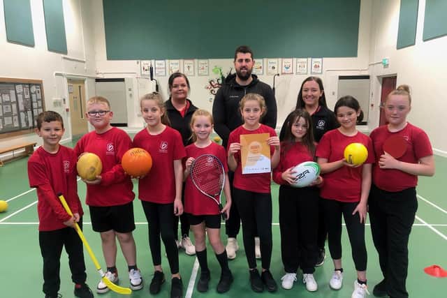 Brougham Primary School pupils with their School Games Gold Award certificate. Pictured back row, from left, are Jenn Hopkins, John Spence and Keighley Bradford.