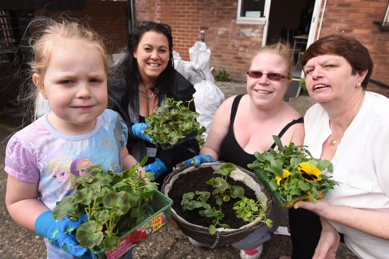 What a lovely floral scene as Sandra and Audrey Hutchinson - along with 4 year old Payton Skinner - were pictured helping Neighbourhood Housing Officer, Denise McGuigan make up hanging baskets.