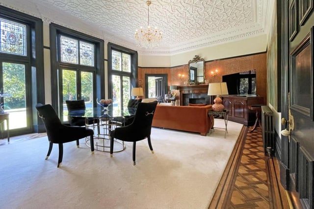 The formal sitting room boasts a delicate Italian style ceiling and cornice.
