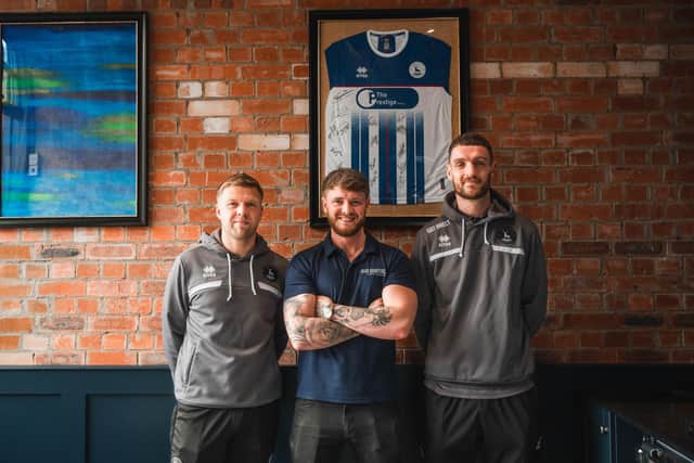 Hartlepool United football players Nicky Featherstone (left) and Luke Waterfall get a pre-match trim at the grand opening of Head Quarters Barbers in Church Street on Saturday, March 16.