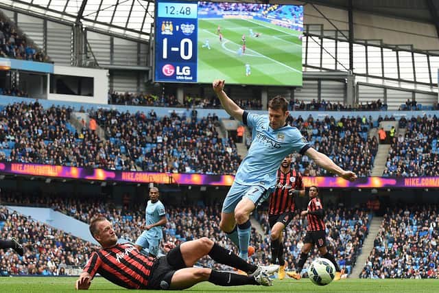 Queens Park Rangers' English defender Clint Hill (L) vies for the ball with Manchester City's English midfielder James Milner during the English Premier League football match between Manchester City and Queens Park Rangers at the Etihad Stadium in Manchester, northwest England, on May 10, 2015.  AFP PHOTO / PAUL ELLIS