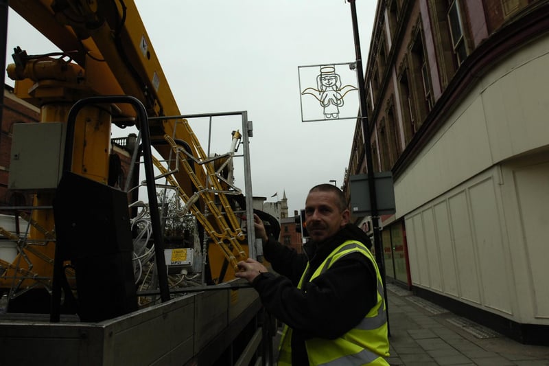 Ian Robinson gets into the Christmas spirit by putting up the town's Christmas lights in 2009.