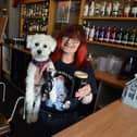 The Fishermans Arms landlady Hazel Whitelock with dog Sunny behind the bar.