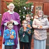 Father Richard Masshedar with members of the 18th Hartlepool St Paul's Beavers and Cubs at the church's Christingle service.