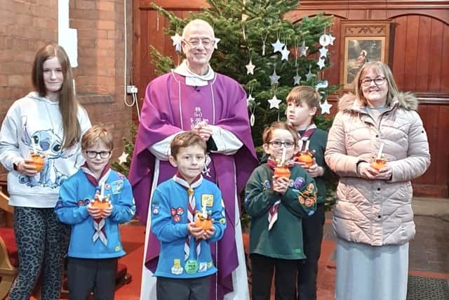Father Richard Masshedar with members of the 18th Hartlepool St Paul's Beavers and Cubs at the church's Christingle service.