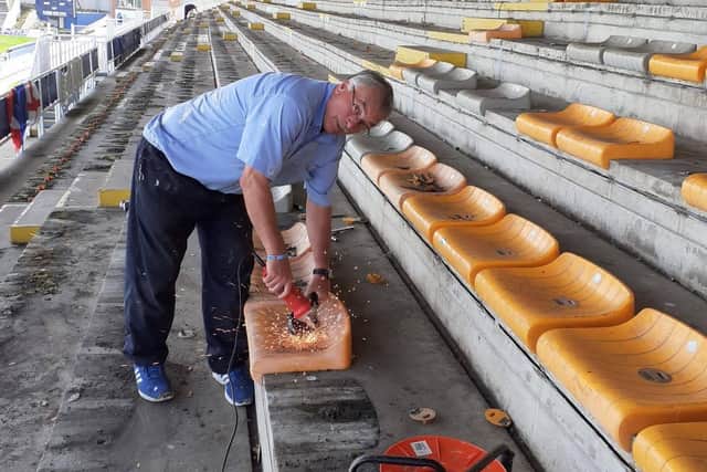 Bill Shurmer helping to remove the old seats at the ground.
