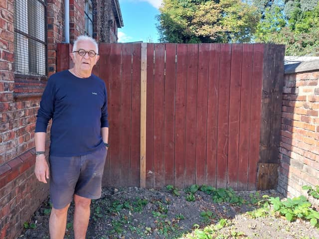 Hartlepool Men's Shed chair Stan Filipowicz by the relocated boundary fence.