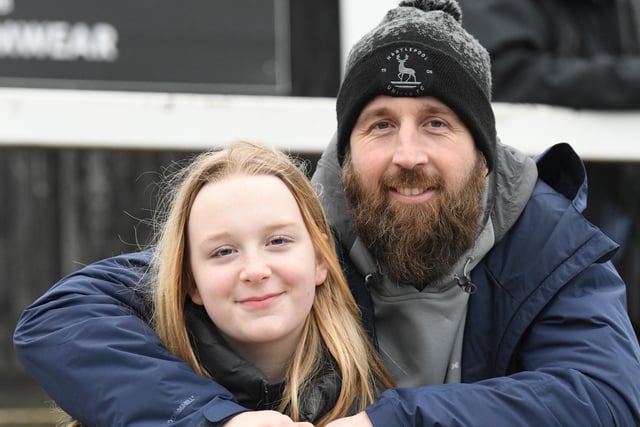 A man and girl enjoying the away day at Bromley.  Picture by FRANK REID