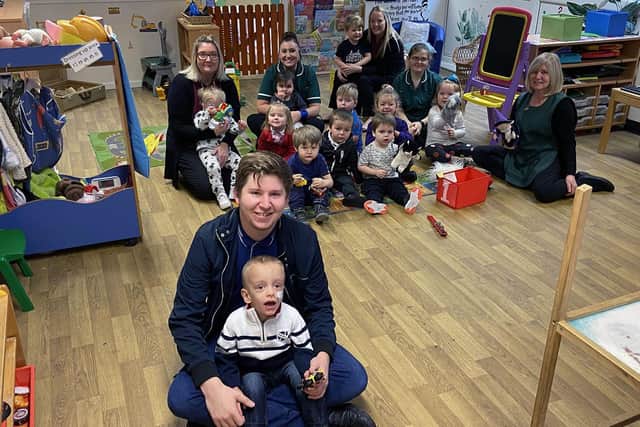 Noah Griffiths with his dad Jamie Greenhow and staff and pupils at Little Stars Nursery. Picture by FRANK REID