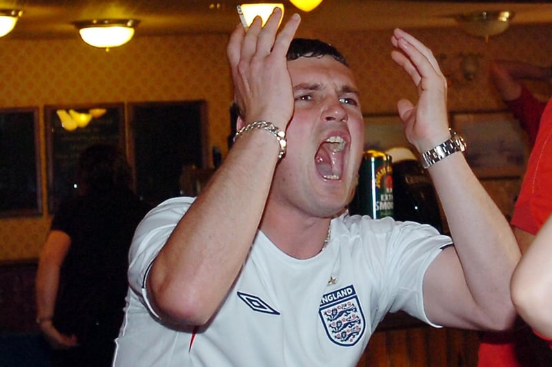 An England fan reacts to another near missing while watching the 2006 World Cup match with Ecuador in The Woodcutter.