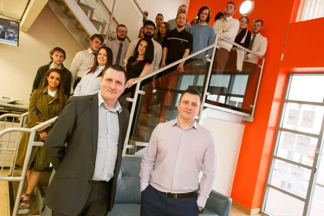 Utility Alliance managing directors Phill Moore, left, and Bob Moore, right, with staff at the Hartlepool office.
