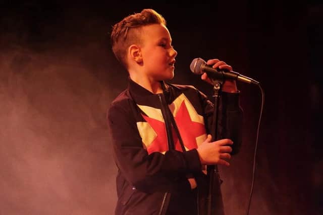 Young singing fundraiser Charlie Aitchinson.