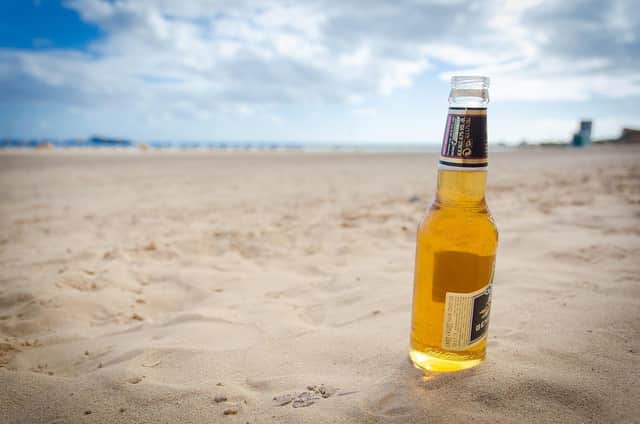Stock image from Pixabay of a bottle of beer at a beach