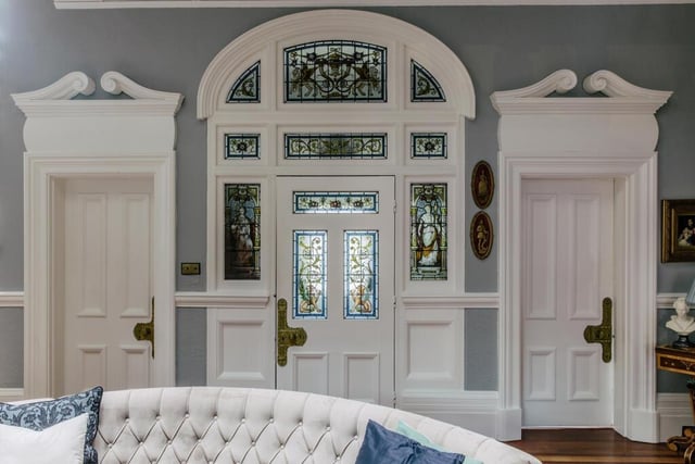 The main entrance hall of this property boasts a large stained glass porch depicting classical motifs and the original owners' crest.