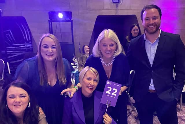 Lyndsay Hogg (top left) with Heather Mills (in the middle, holding a 22 sign). The teams were sat on table 22 and Lyndsay said Heather joked if the 22 meant 22% off her freight bill in future.