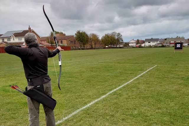 A member of Hartlepool's Heugh Bowmen archery club in action on an outdoor range.