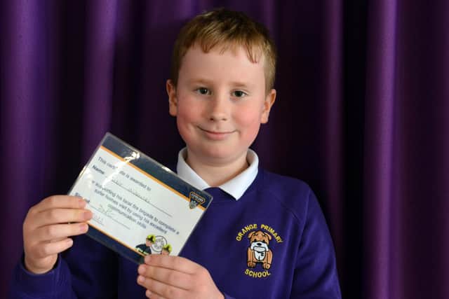 Grange Primary School pupil Victor Wilewski with the certificate he was presented with by the fire brigade.
