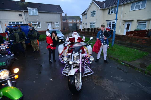 Santa Clause brings gifts for Noah Griffiths who is held by his dad Jamie Greenhow as his mum Abbieleigh Griffiths with his sister Ivy Greenhow look on. Picture by Frank Reid