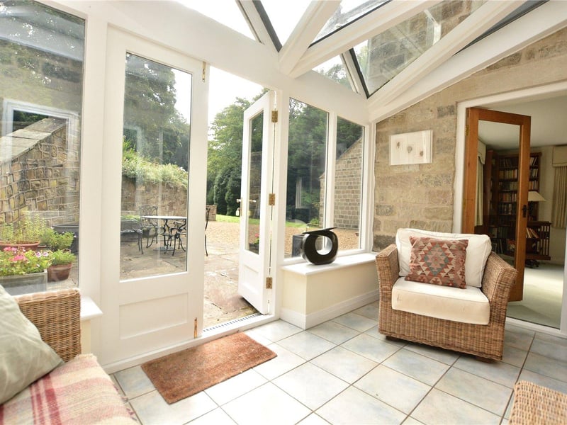 Bright and airy, the conservatory serves as another sitting room and enjoys wonderful views over the garden, with double doors leading outside.
