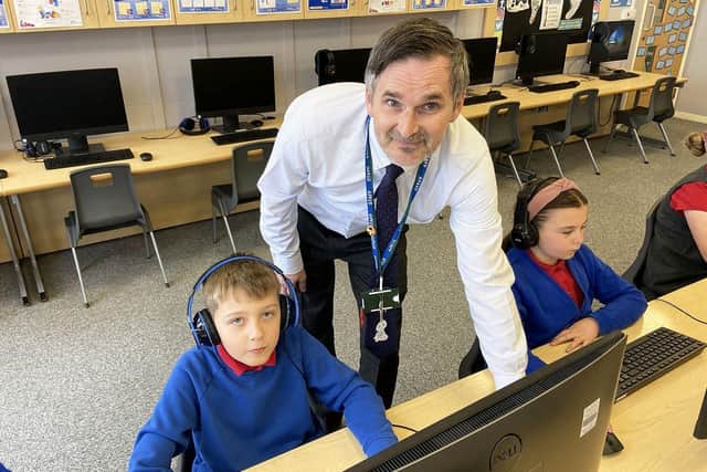 Throston Primary school pupil Charlie Hutchinson  with teacher Stephen Molyneux taking part in online learning at Throston Primary School.