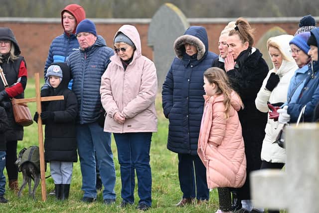 Parishioners and friends of St. Mary’s Church, on the Headland, gather at the grave of Canon William Knight.