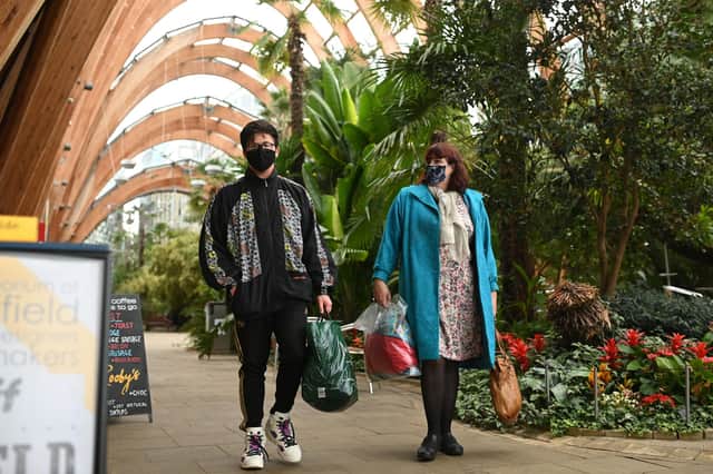 A couple wearing protective face masks, walk through The Winter Garden in Sheffield (Photo by Oli SCARFF / AFP) (Photo by OLI SCARFF/AFP via Getty Images)