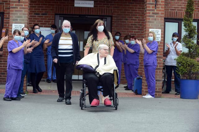 John Davison (left) and wife Joan pushed in the wheelchair by their daughter Jackie Williams leave Alice House Hospice for home while being applauded by care staff.